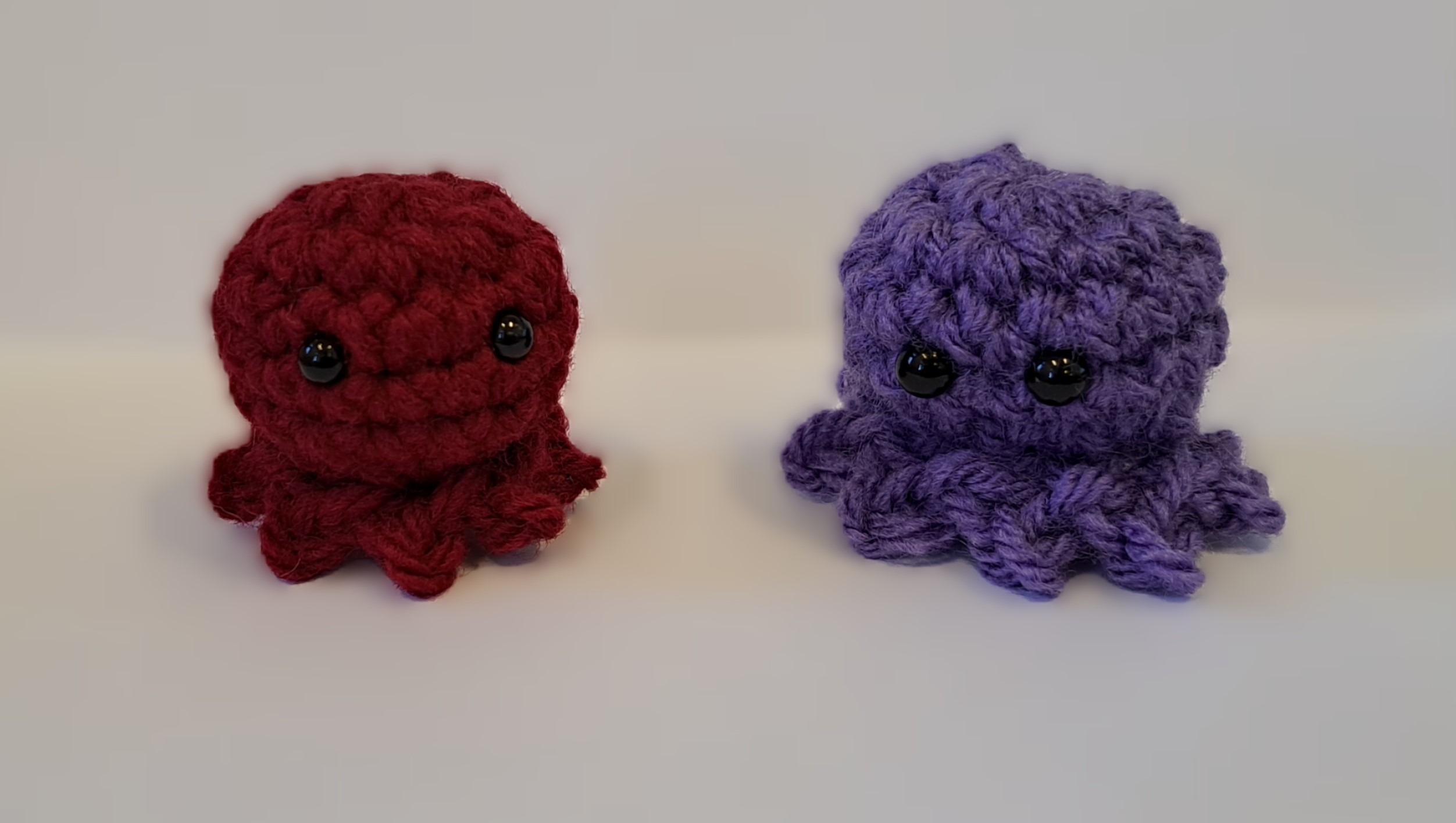 crocheted maroon and purple tiny octopuses